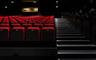 Red theatre seats and stairs beside them